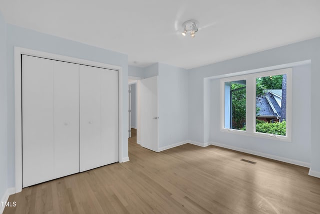 3205 Dell Dr, Raleigh, NC 27609 - unfurnished bedroom featuring wood finished floors and a closet