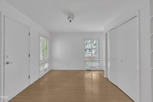 3205 Dell Dr, Raleigh, NC 27609 - unfurnished bedroom with light wood finished floors and baseboards