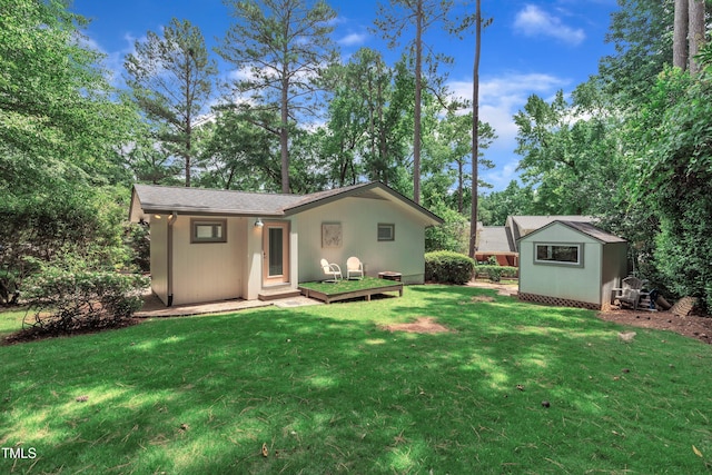 3205 Dell Dr, Raleigh, NC 27609 - back of house with an outdoor structure, a lawn, and view of scattered trees