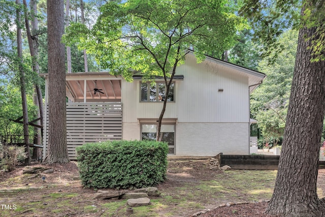 3205 Dell Dr, Raleigh, NC 27609 - view of side of home featuring brick siding and ceiling fan