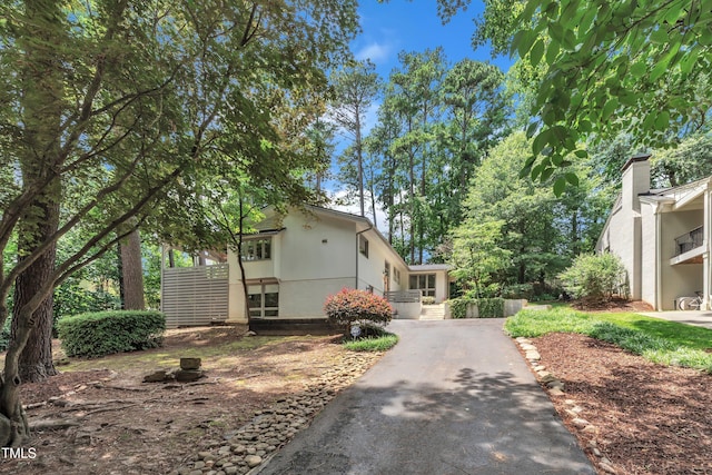 3205 Dell Dr, Raleigh, NC 27609 - view of side of home with stucco siding and asphalt driveway