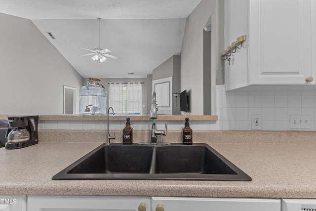 3159 Wisteria Ln Unit 202, Fayetteville, NC 28314 - kitchen with vaulted ceiling, tasteful backsplash, a ceiling fan, white cabinets, and light countertops