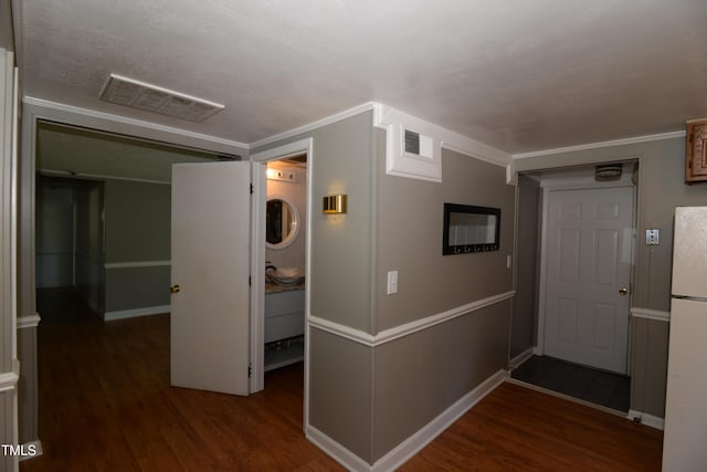 521 S Lombard St, Clayton, NC 27520 - corridor with wood finished floors, stacked washer / dryer, and crown molding