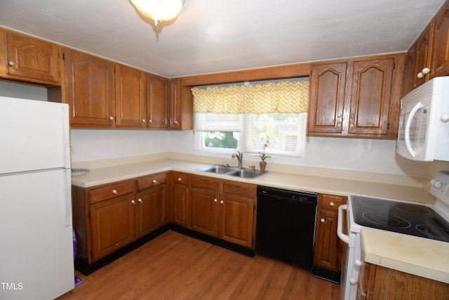 521 S Lombard St, Clayton, NC 27520 - kitchen with white appliances, brown cabinets, light wood-style floors, and light countertops
