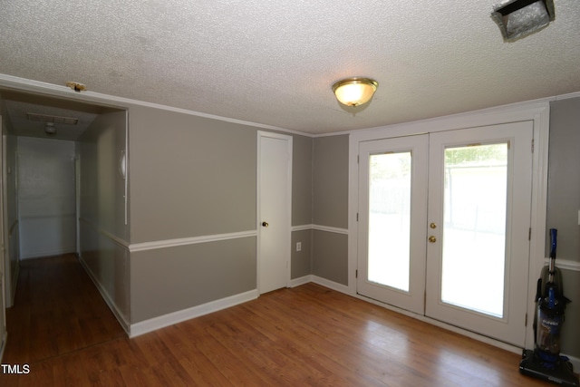 521 S Lombard St, Clayton, NC 27520 - unfurnished room featuring french doors, wood finished floors, and a textured ceiling
