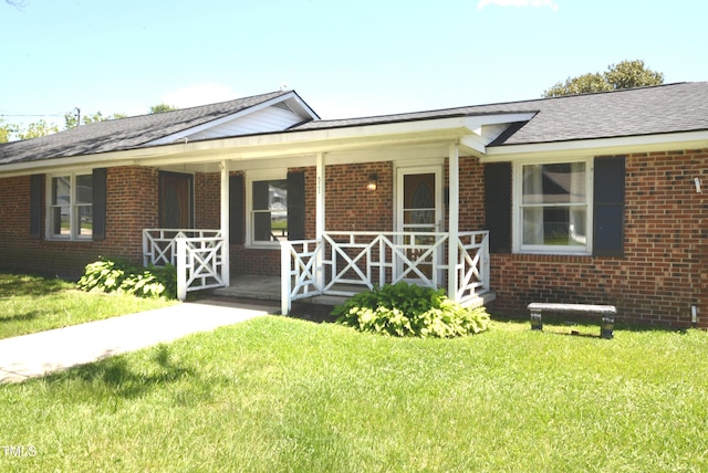521 S Lombard St, Clayton, NC 27520 - ranch-style house featuring a porch, a front yard, and brick siding