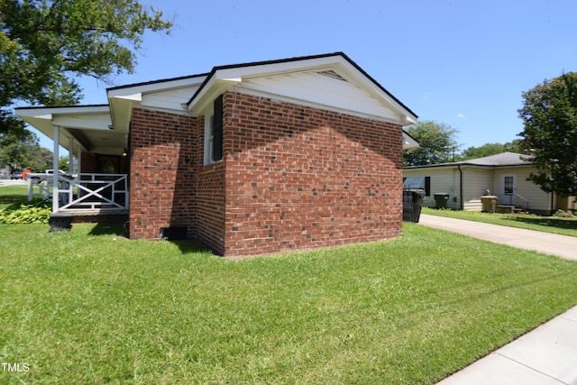 521 S Lombard St, Clayton, NC 27520 - view of property exterior with a yard and brick siding
