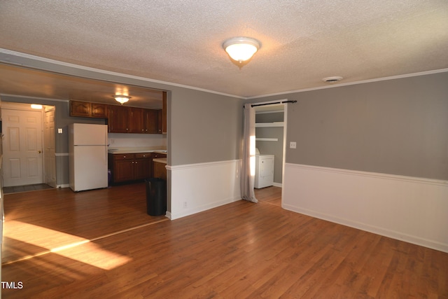 521 S Lombard St, Clayton, NC 27520 - unfurnished living room featuring a textured ceiling, washer / clothes dryer, dark wood-style flooring, and ornamental molding