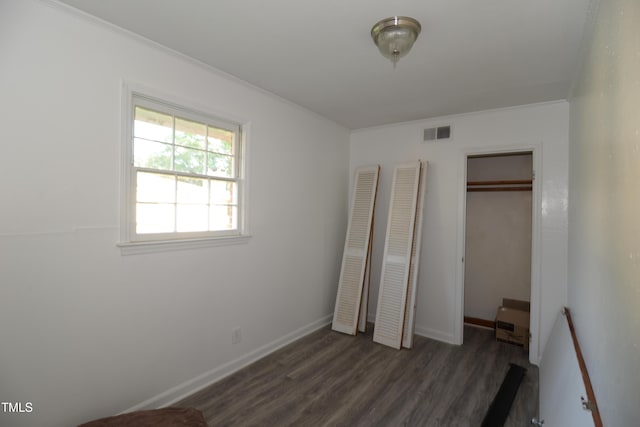 521 S Lombard St, Clayton, NC 27520 - unfurnished bedroom with dark wood finished floors, a closet, and ornamental molding