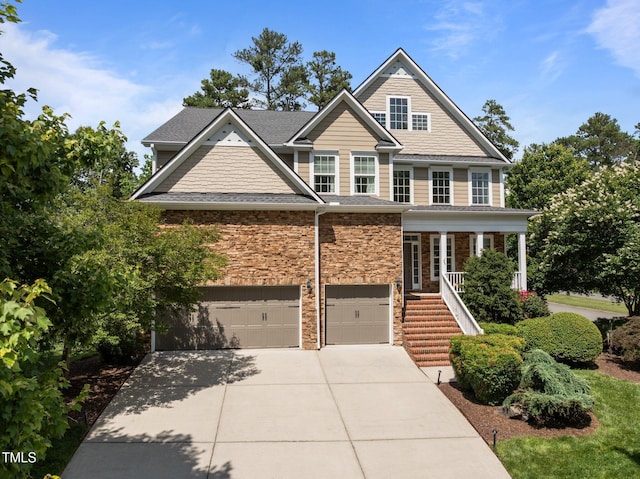 705 Harkness Cir, Durham, NC 27705 - view of front of home featuring an attached garage, stairs, concrete driveway, roof with shingles, and stone siding