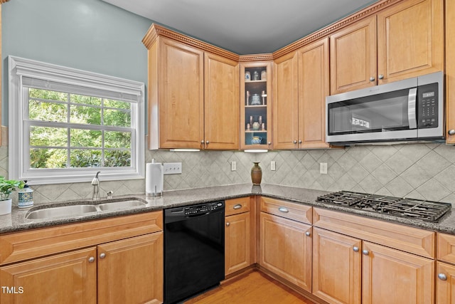 705 Harkness Cir, Durham, NC 27705 - kitchen with black dishwasher, stainless steel microwave, gas stovetop, dark stone countertops, and glass insert cabinets