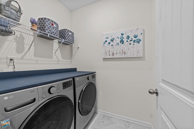 3613 Cross Timber Ln, Raleigh, NC 27603 - laundry room with washer and clothes dryer and marble look tiles