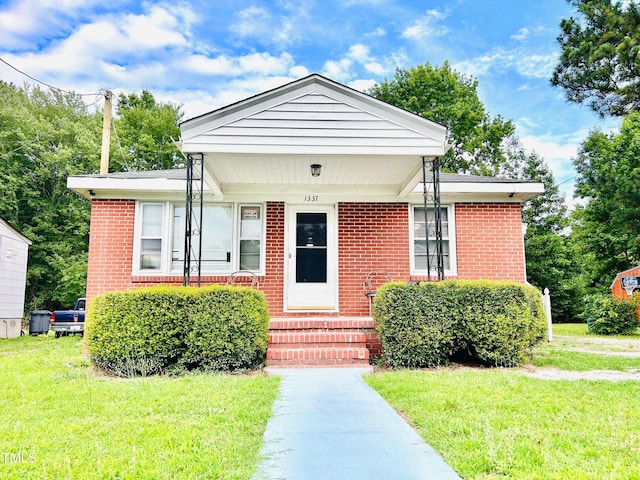 1337 Maple St, Rocky Mount, NC 27803 - bungalow featuring a front lawn, entry steps, and brick siding