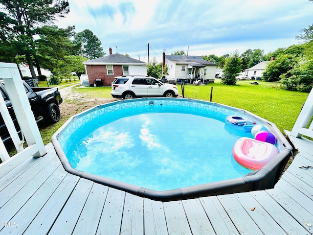 1337 Maple St, Rocky Mount, NC 27803 - view of swimming pool with a deck, a lawn, and a residential view