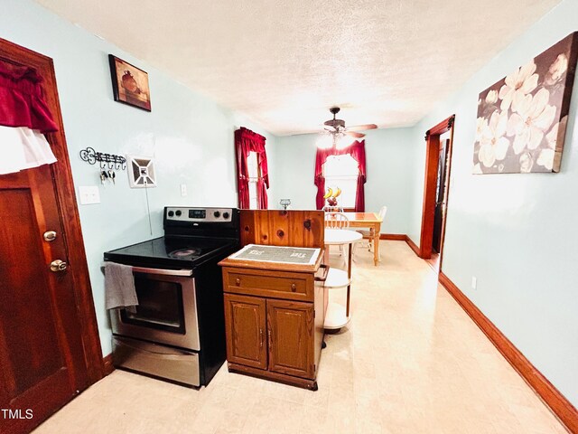 1337 Maple St, Rocky Mount, NC 27803 - kitchen featuring stainless steel range with electric cooktop, a textured ceiling, light flooring, a ceiling fan, and brown cabinets