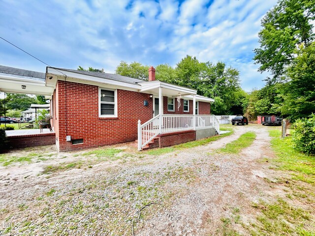 1337 Maple St, Rocky Mount, NC 27803 - view of front of house with a chimney, brick siding, and driveway