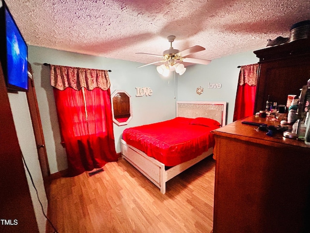 1337 Maple St, Rocky Mount, NC 27803 - bedroom featuring wood finished floors, a textured ceiling, and a ceiling fan