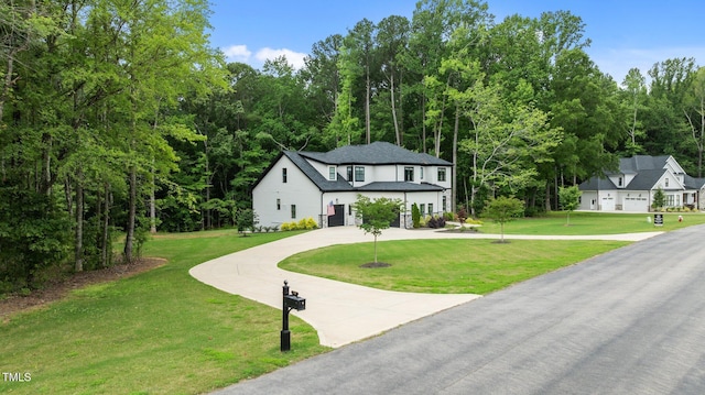 310 Hidden Lake Dr, Youngsville, NC 27596 - view of front of house featuring curved driveway and a front lawn