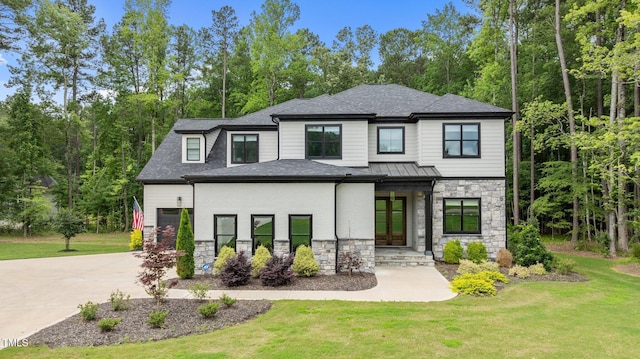 310 Hidden Lake Dr, Youngsville, NC 27596 - view of front of property featuring stone siding, a front lawn, and driveway