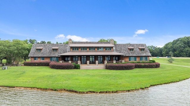 310 Hidden Lake Dr, Youngsville, NC 27596 - rear view of property featuring a chimney, a yard, a water view, and a metal roof
