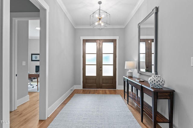 310 Hidden Lake Dr, Youngsville, NC 27596 - entrance foyer featuring french doors, wood finished floors, crown molding, and a chandelier