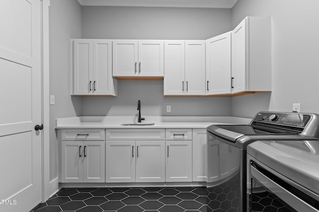 310 Hidden Lake Dr, Youngsville, NC 27596 - laundry area with washer and dryer, cabinet space, and dark tile patterned floors