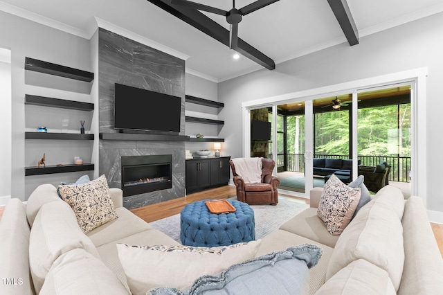 310 Hidden Lake Dr, Youngsville, NC 27596 - living area featuring wood finished floors, ornamental molding, ceiling fan, a fireplace, and beamed ceiling