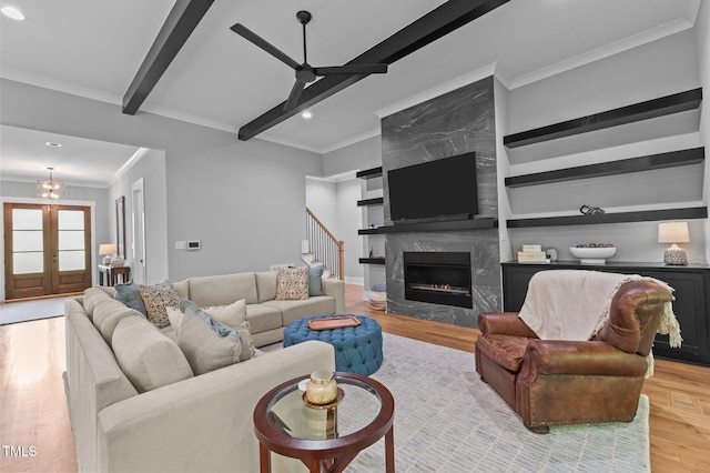 310 Hidden Lake Dr, Youngsville, NC 27596 - living room featuring wood finished floors, crown molding, beamed ceiling, a ceiling fan, and stairway