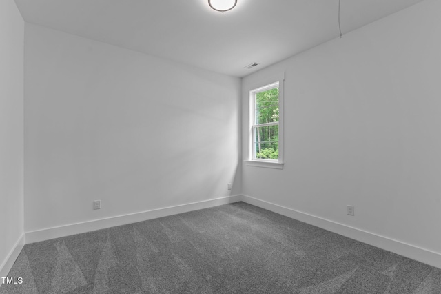 310 Hidden Lake Dr, Youngsville, NC 27596 - empty room with dark carpet and baseboards