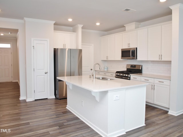 2002 Strickland Oak Way, Durham, NC 27703 - kitchen with appliances with stainless steel finishes, recessed lighting, dark wood-style floors, backsplash, and ornamental molding
