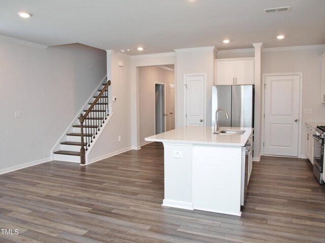 2002 Strickland Oak Way, Durham, NC 27703 - kitchen featuring appliances with stainless steel finishes, crown molding, dark wood-style floors, recessed lighting, and an island with sink