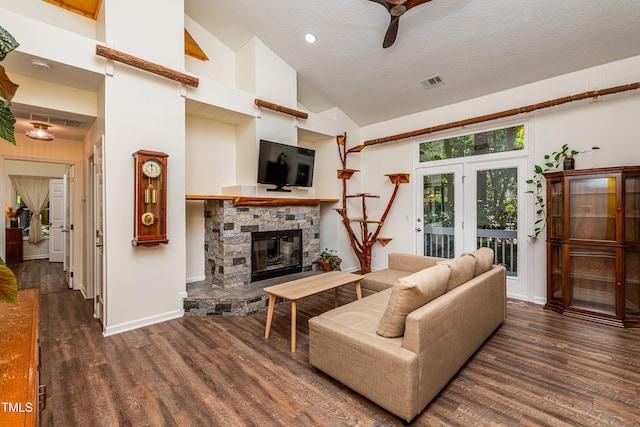 3616 Culater Ct, Raleigh, NC 27616 - living room with wood finished floors, a stone fireplace, a ceiling fan, high vaulted ceiling, and a textured ceiling