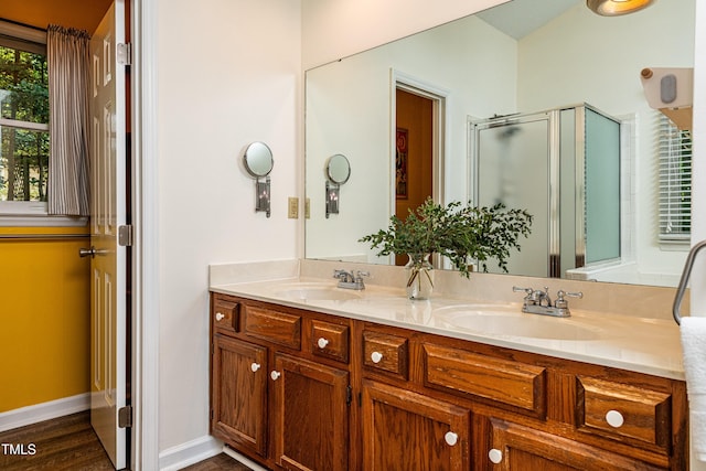 3616 Culater Ct, Raleigh, NC 27616 - bathroom with double vanity, a shower stall, and wood finished floors
