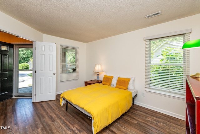 3616 Culater Ct, Raleigh, NC 27616 - bedroom with dark wood finished floors, multiple windows, and a textured ceiling