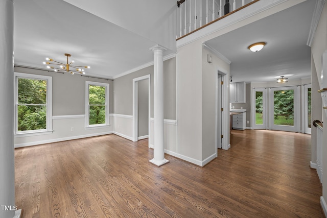6001 Waters Way Dr, Raleigh, NC 27606 - unfurnished living room featuring ornate columns, wood finished floors, ornamental molding, and a chandelier