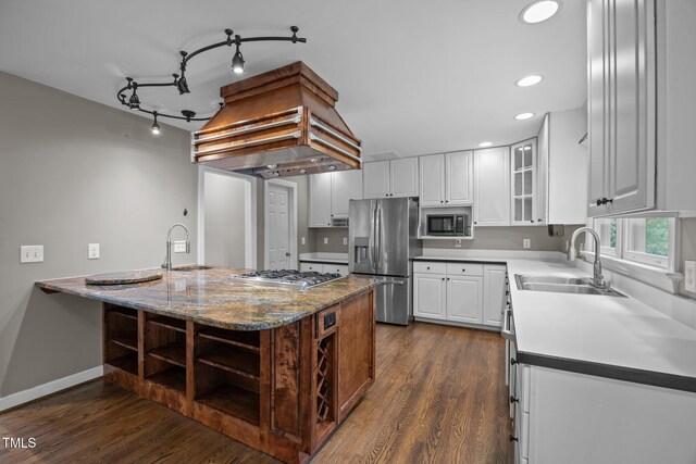 6001 Waters Way Dr, Raleigh, NC 27606 - kitchen with appliances with stainless steel finishes, dark wood-style flooring, white cabinetry, glass insert cabinets, and recessed lighting
