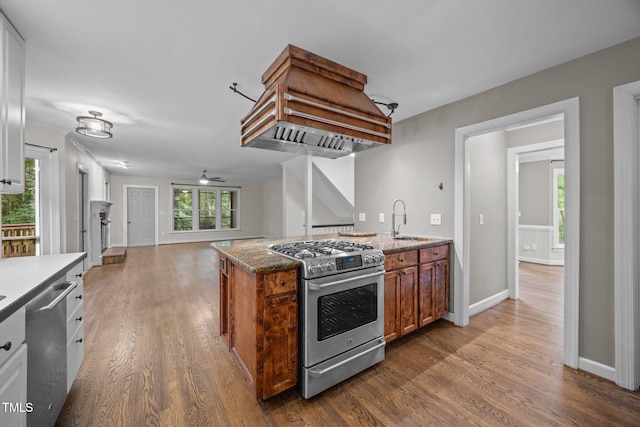 6001 Waters Way Dr, Raleigh, NC 27606 - kitchen with appliances with stainless steel finishes, custom range hood, dark wood-style flooring, and a ceiling fan