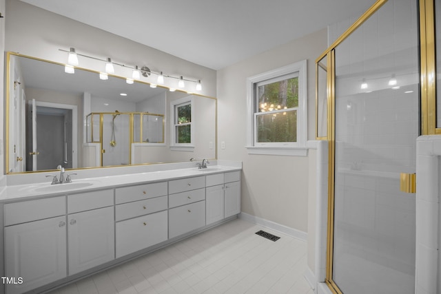 6001 Waters Way Dr, Raleigh, NC 27606 - bathroom featuring double vanity, a shower stall, and tile patterned flooring