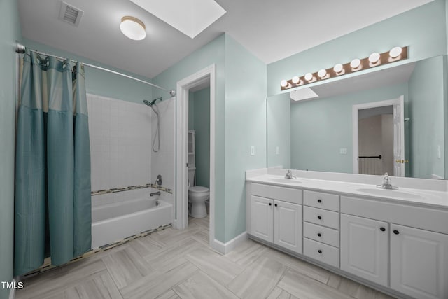 6001 Waters Way Dr, Raleigh, NC 27606 - bathroom with a skylight, shower / bath combination with curtain, and double vanity