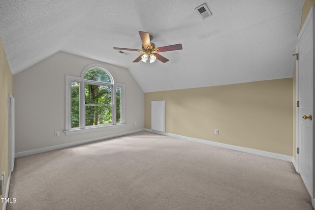 6001 Waters Way Dr, Raleigh, NC 27606 - bonus room with a ceiling fan, vaulted ceiling, light carpet, and a textured ceiling