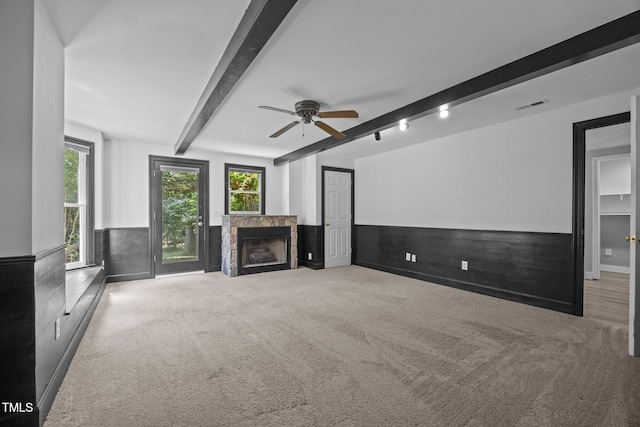 6001 Waters Way Dr, Raleigh, NC 27606 - unfurnished living room with beamed ceiling, a fireplace, wainscoting, ceiling fan, and carpet flooring