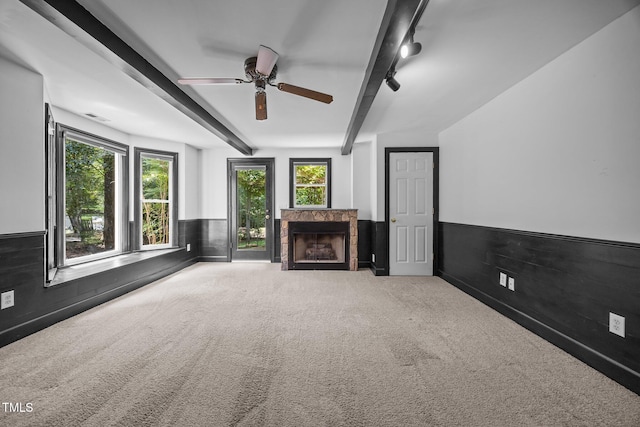 6001 Waters Way Dr, Raleigh, NC 27606 - unfurnished living room with beam ceiling, carpet floors, a fireplace, ceiling fan, and wainscoting