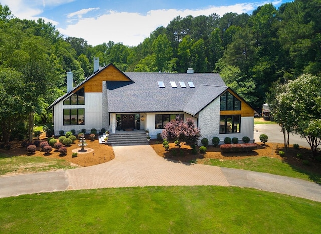 1004 Buttar Ln, Raleigh, NC 27614 - view of front of house featuring a shingled roof, a chimney, a front lawn, and driveway