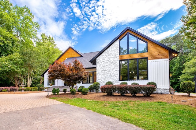 1004 Buttar Ln, Raleigh, NC 27614 - view of front of home with a front yard, stone siding, and decorative driveway