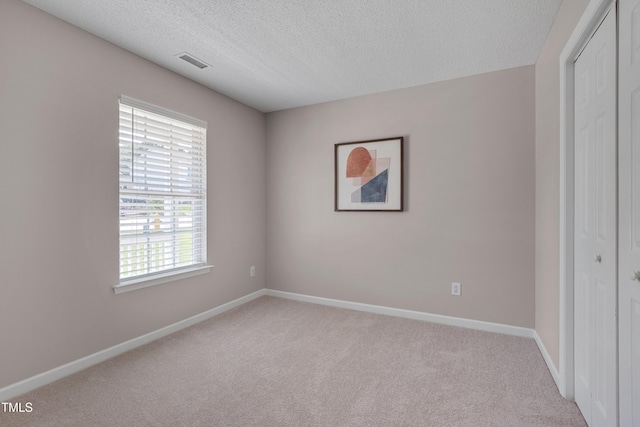 5000 Silverdene St, Raleigh, NC 27616 - unfurnished bedroom featuring a closet, carpet flooring, and a textured ceiling