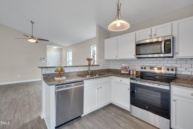 5000 Silverdene St, Raleigh, NC 27616 - kitchen with appliances with stainless steel finishes, light wood-style flooring, a ceiling fan, lofted ceiling, and backsplash