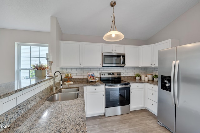 5000 Silverdene St, Raleigh, NC 27616 - kitchen with stainless steel appliances, decorative backsplash, white cabinetry, light stone counters, and lofted ceiling