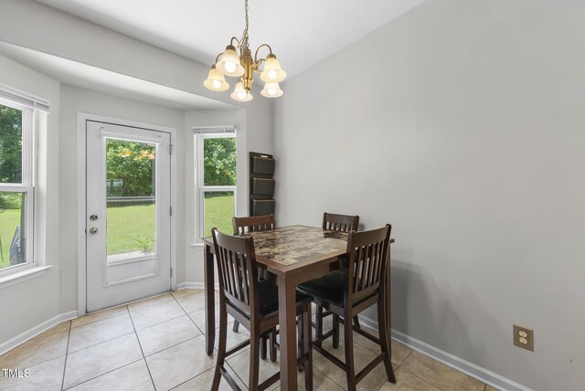 702 Pitch Pine Dr, Creedmoor, NC 27522 - dining space with a chandelier and light tile patterned floors