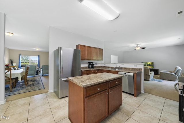 702 Pitch Pine Dr, Creedmoor, NC 27522 - kitchen with appliances with stainless steel finishes, a peninsula, open floor plan, ceiling fan, and a kitchen island