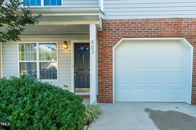 803 Creek Crossing Trl, Whitsett, NC 27377 - view of exterior entry with brick siding and concrete driveway